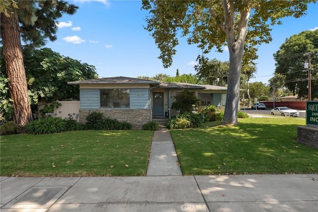 613 E Chapman Ave, Fullerton, CA 92831 - view of front facade featuring a front lawn and stone siding