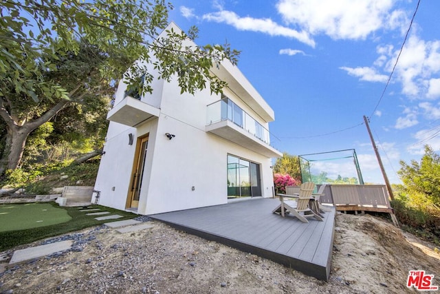 rear view of house with a wooden deck