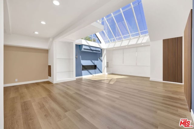 unfurnished living room with light hardwood / wood-style flooring and a wall mounted AC