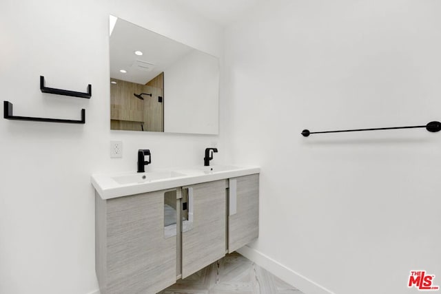 bathroom with a shower, vanity, and parquet floors