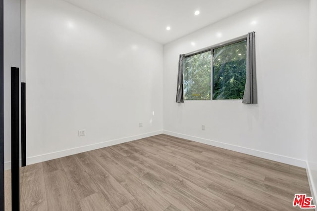 spare room featuring light wood-type flooring