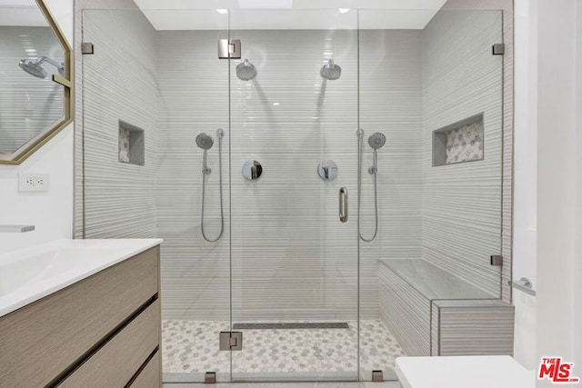 bathroom with an enclosed shower and vanity