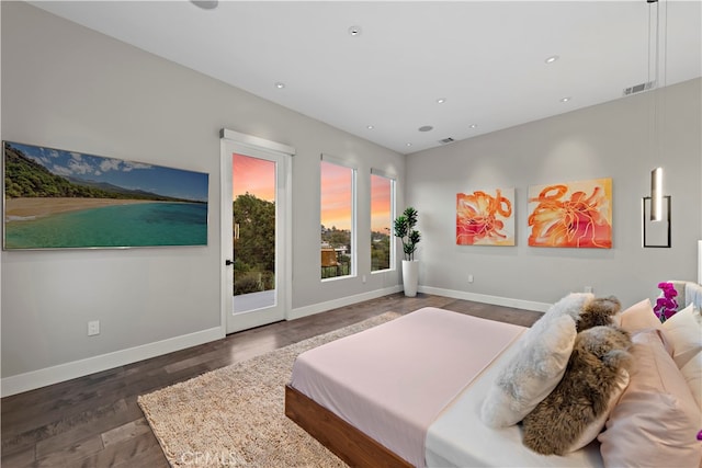 bedroom featuring dark hardwood / wood-style floors and access to exterior