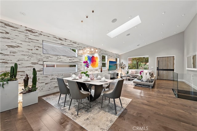 dining area featuring a skylight, dark wood-type flooring, and high vaulted ceiling