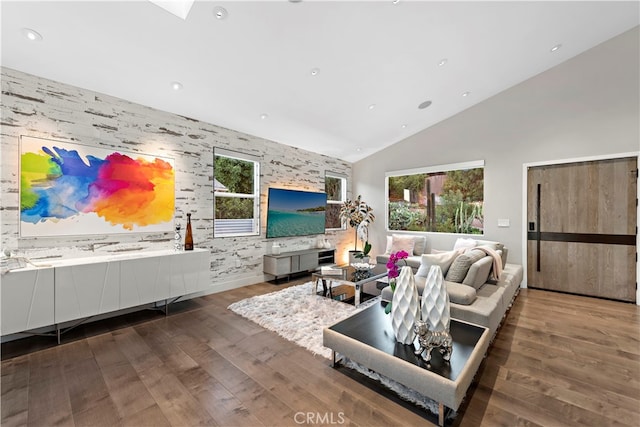 living room with high vaulted ceiling and dark wood-type flooring