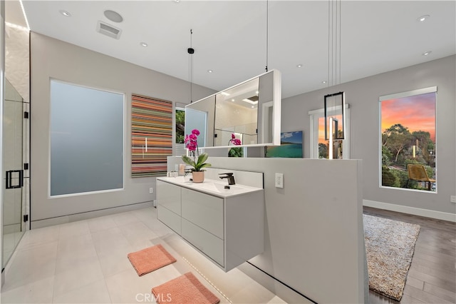 bathroom featuring an enclosed shower, hardwood / wood-style flooring, and vanity