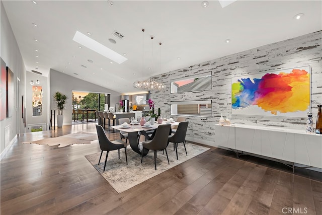 dining space with vaulted ceiling with skylight and dark hardwood / wood-style floors