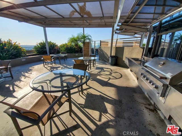 view of patio / terrace with a pergola, grilling area, and sink