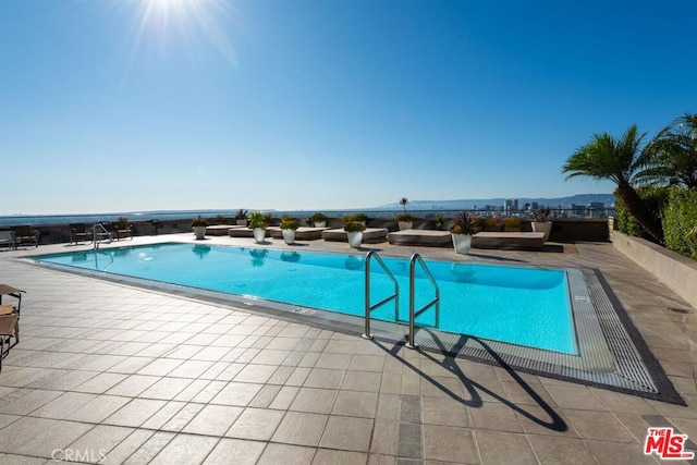 view of pool featuring a patio and a mountain view