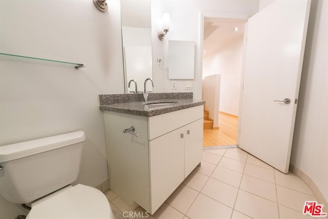 bathroom featuring vanity, toilet, and tile patterned floors