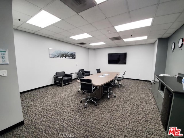 office with a drop ceiling and dark colored carpet