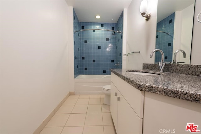 full bathroom featuring tile patterned flooring, vanity, toilet, and tiled shower / bath