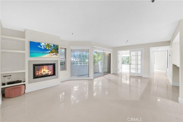 unfurnished living room with light tile patterned floors and built in shelves