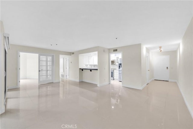 unfurnished living room featuring light tile patterned flooring