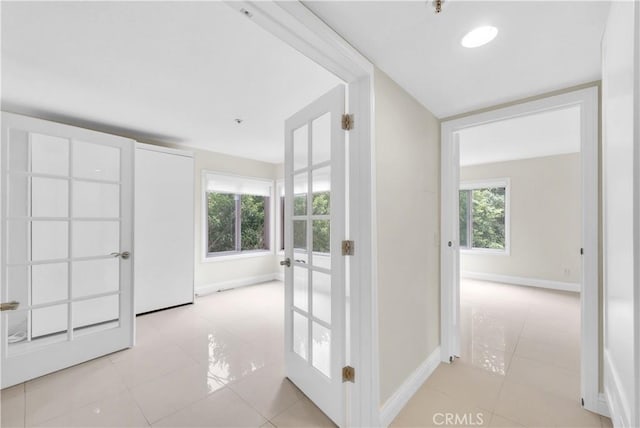 260 Cagney Ln Unit 105, Newport Beach, CA 92663 - hallway with french doors and light tile patterned floors