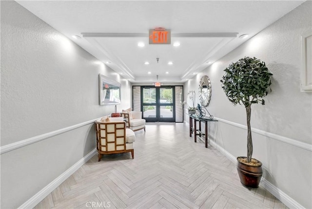 260 Cagney Ln Unit 105, Newport Beach, CA 92663 - corridor with baseboards, recessed lighting, a raised ceiling, and a textured wall