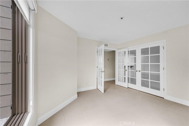 unfurnished bedroom featuring french doors