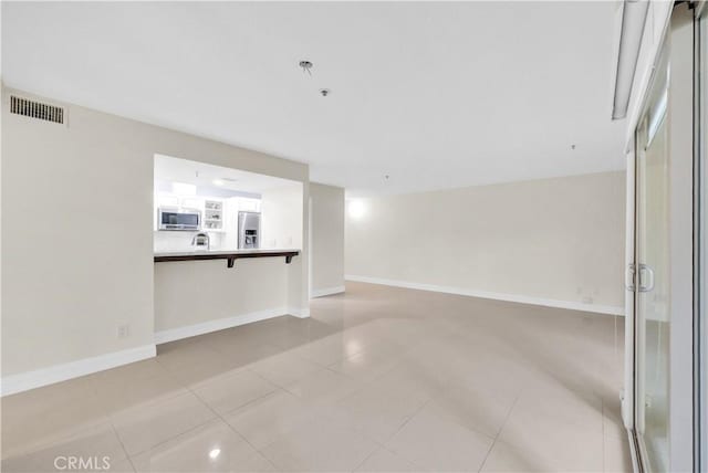 260 Cagney Ln Unit 105, Newport Beach, CA 92663 - empty room featuring light tile patterned floors and baseboards
