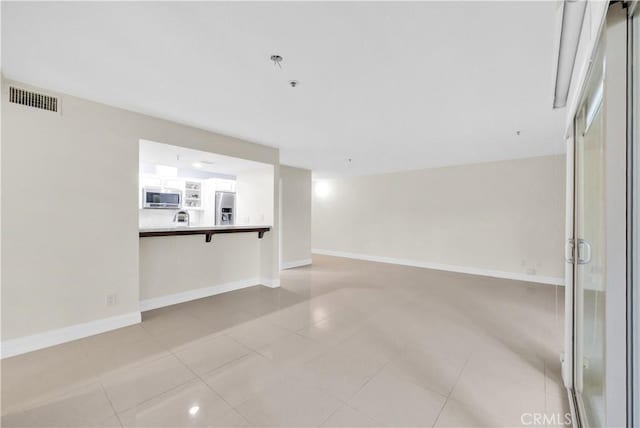 260 Cagney Ln Unit 105, Newport Beach, CA 92663 - spare room featuring light tile patterned floors and baseboards