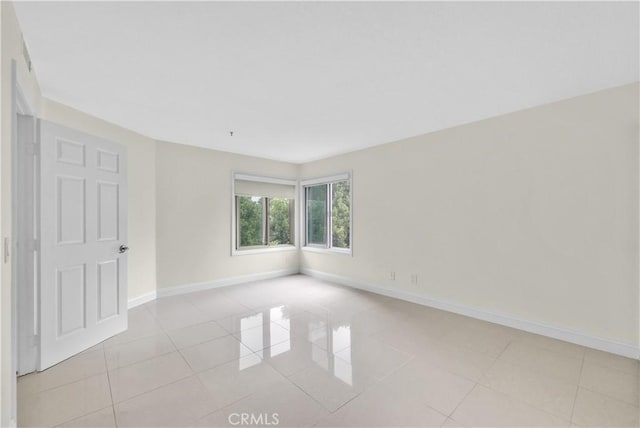 unfurnished room featuring light tile patterned floors