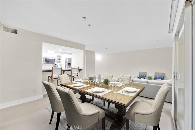 dining space with light tile patterned flooring