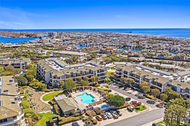 260 Cagney Ln Unit 105, Newport Beach, CA 92663 - drone / aerial view of a pool and a large body of water