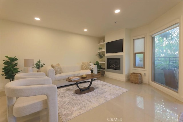 260 Cagney Ln Unit 105, Newport Beach, CA 92663 - tiled living room with recessed lighting and a glass covered fireplace