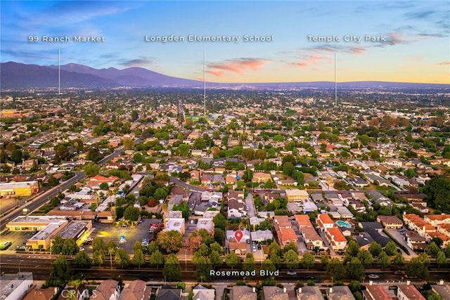 aerial view at dusk featuring a mountain view