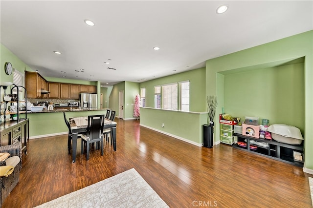 dining area with dark hardwood / wood-style floors