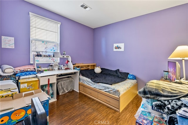 bedroom with dark hardwood / wood-style floors