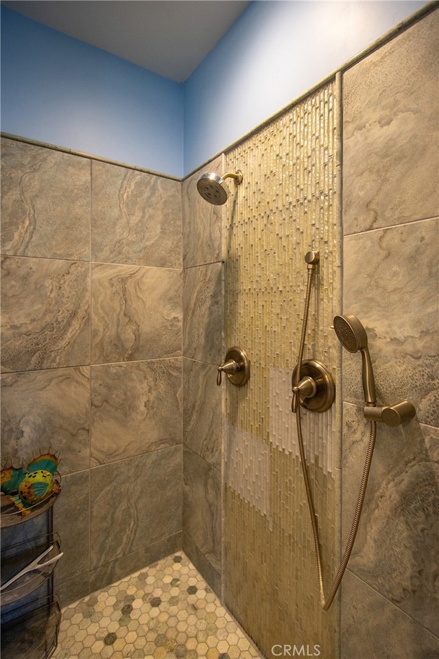 bathroom with a tile shower