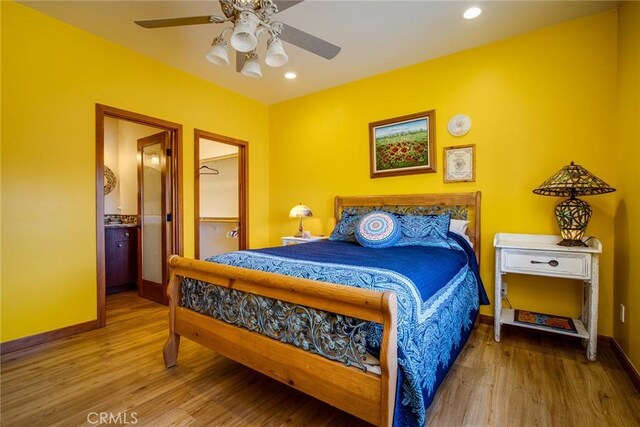 bedroom featuring wood-type flooring, ceiling fan, and ensuite bathroom