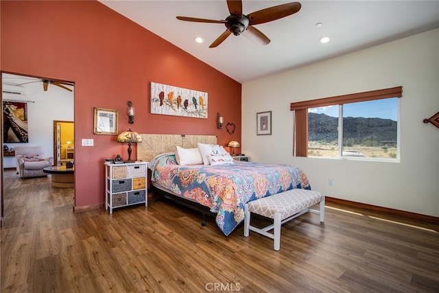 bedroom featuring ceiling fan, dark wood-type flooring, and high vaulted ceiling