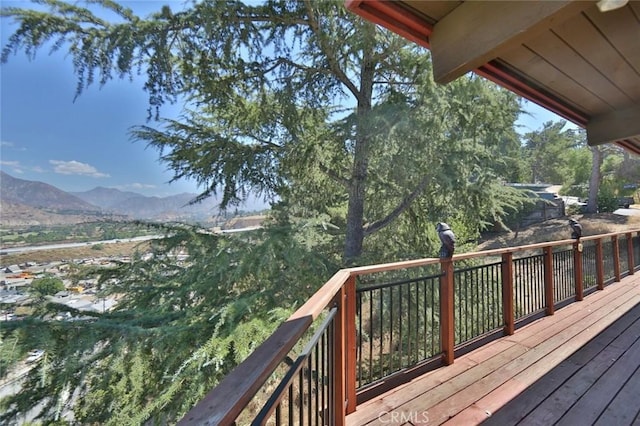 wooden deck with a mountain view