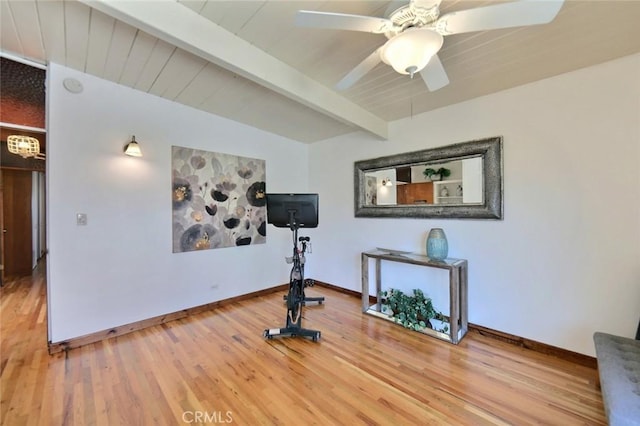 workout area with ceiling fan, hardwood / wood-style floors, and vaulted ceiling