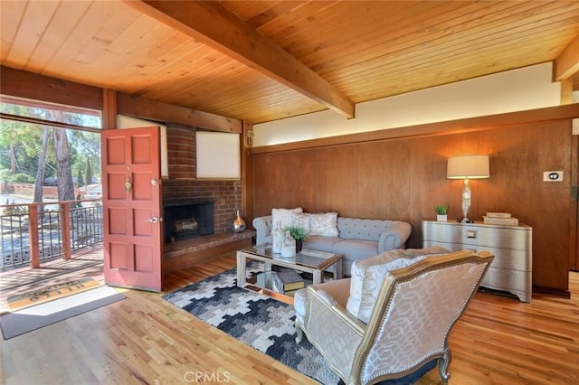 living room with wood walls, a brick fireplace, light hardwood / wood-style flooring, beam ceiling, and wood ceiling