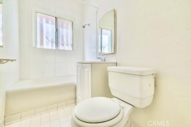 bathroom featuring tile patterned flooring, shower / bath combination, toilet, and plenty of natural light