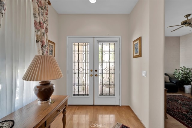 doorway to outside with light wood-type flooring, ceiling fan, and french doors