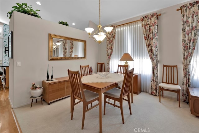 dining room with an inviting chandelier and light wood-type flooring