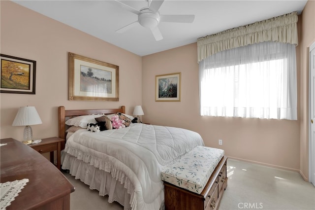 bedroom featuring ceiling fan and light colored carpet