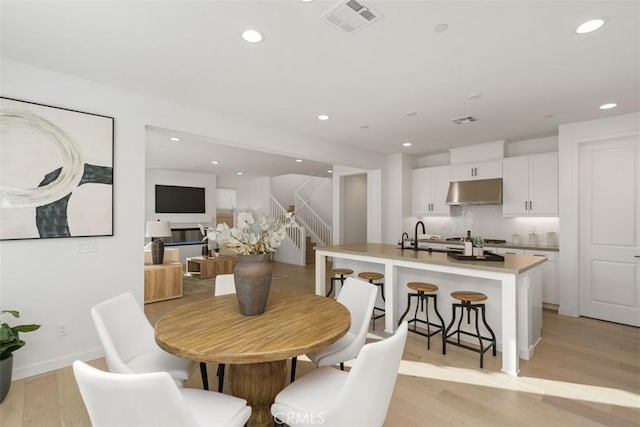 dining space with light hardwood / wood-style floors