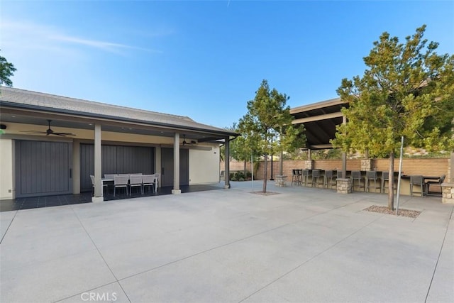 view of patio featuring ceiling fan and exterior bar