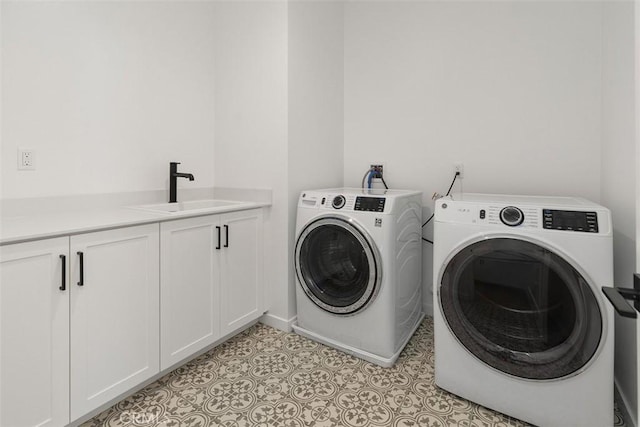 laundry area with cabinets, sink, light tile patterned floors, and independent washer and dryer