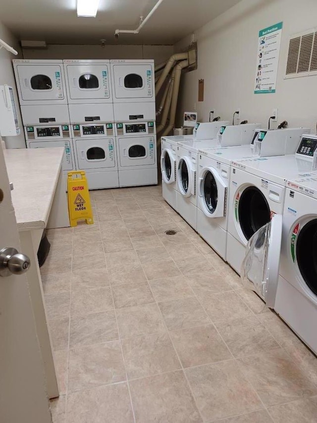 washroom with stacked washing maching and dryer and washing machine and clothes dryer