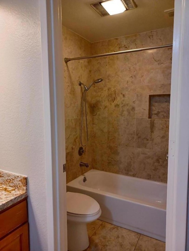 full bathroom featuring toilet, vanity, tile patterned flooring, and tiled shower / bath combo