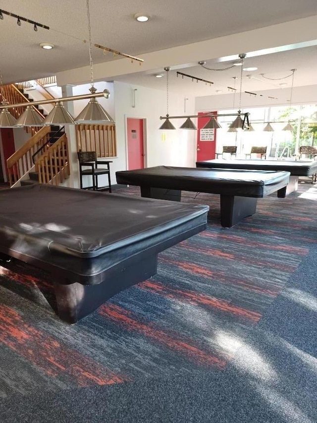 game room with a textured ceiling, carpet, and billiards