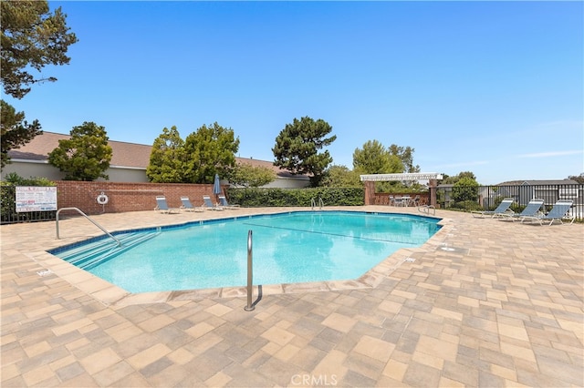 view of pool with a pergola and a patio area