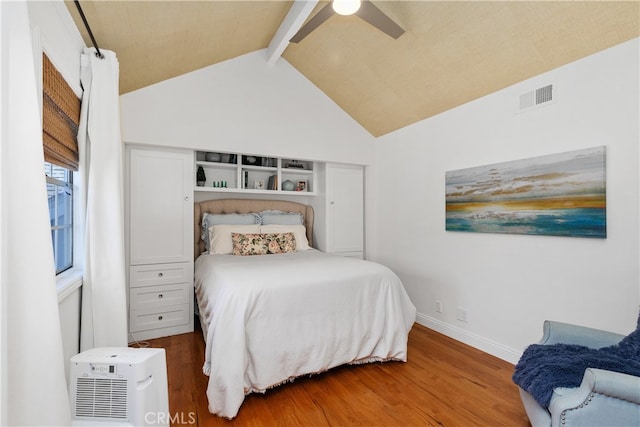 bedroom featuring lofted ceiling with beams, ceiling fan, and hardwood / wood-style flooring