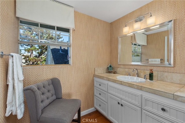 bathroom with a wealth of natural light, hardwood / wood-style floors, and vanity