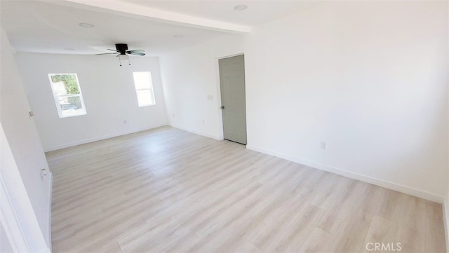 empty room featuring beamed ceiling, ceiling fan, and light hardwood / wood-style flooring